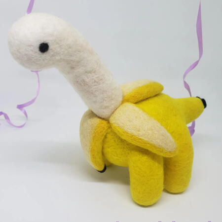 Bananasaurus Banana Dinosaur Needle felted figure of a yellow dinosaur made to look like a banana being peeled