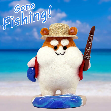 Gone Fishing Hamster Needle felted figure of an orange and white hamster in a little straw hat with a fishing pole and a fish. It's on a clay base with an ocean wave.